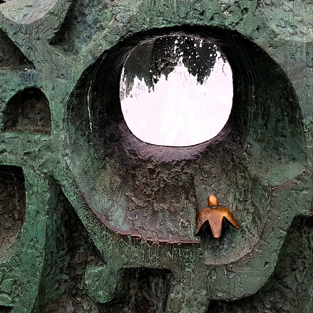 Ein Bild einer Mauer mit Loch und einem Vogel aus Ton